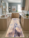 2.8' x 8' runner beige & blue abstract watercolor modern area rug placed in a modern kitchen with light cabinetry and brass accents.