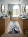 2.8' x 8' runner ivory & blue abstract watercolor modern area rug placed in a serene bathroom with dual vanities and a freestanding tub.
