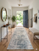2.8' x 8' runner ivory & blue distressed linear modern area rug styled in an entryway with a wooden bench, console table, and natural light.