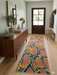 2.8' x 8' runner multicolor terracotta & blue abstract organic geometric modern area rug styled in an entryway with a wooden console table, mirror, and natural decor.