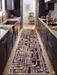 2.8' x 8' runner taupe & brown geometric maze modern area rug placed in a contemporary kitchen with dark cabinetry and brass accents.
