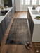 2' x 3' Rectangular Brown Distressed Minimalist Vintage Area Rug styled in a modern kitchen.