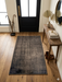 2' x 3' Rectangular Brown Distressed Minimalist Vintage Area Rug styled in an entryway hallway
