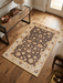 2' x 3' Rectangular Brown & Ivory Floral Traditional Washable Area Rug placed in a rustic entryway beside a wooden console table.