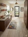 2' x 3' Rectangular Gray Gold Abstract Modern Washable Area Rug styled in a bright laundry room with dark wood cabinetry, open shelving, and a glass-paneled back door.