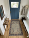 2' x 3' Rectangular Ivory & Blue Geometric Tribal Traditional Area Rug placed in a welcoming entryway.