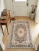 2' x 3' Rectangular Ivory Multi Color Floral Medallion Traditional Area Rug styled in an entryway.