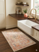 2' x 3' Rectangular Ivory Rust Distressed Medallion Vintage Traditional Area Rug placed in a kitchen sink area adding a soft vintage accent to the space.