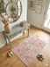 2' x 3' Rectangular Pink Ivory Distressed Medallion Vintage Traditional Area Rug styled in an entryway.