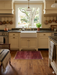 2' x 3' Rectangular Red & Black Geometric Medallion Traditional Washable Area Rug placed in a cozy kitchen in front of a farmhouse sink with warm cabinetry and natural light.