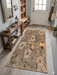 2' x 4' Rectangular Beige & Brown Floral Botanical Modern Washable Area Rug placed in an entryway beside a wooden console table and shoe storage.