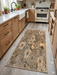 2' x 4' Rectangular Beige & Brown Floral Botanical Modern Washable Area Rug styled in a modern kitchen with light wood cabinets.
