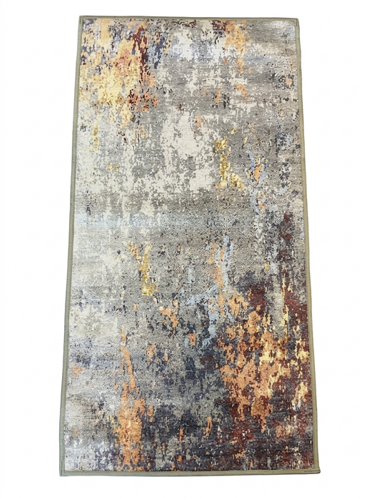 2' x 4' Rectangular Gray Gold Abstract Modern Washable Area Rug placed in a bright hallway with a woven bench, wood console table, and round wall mirror.