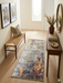 2' x 4' Rectangular Gray Gold Abstract Modern Washable Area Rug styled in a bright entryway with a woven bench, wooden console table, round wall mirror, and natural decor accents.