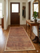2' x 4' Rectangular Rust Orange & Beige Solid Textured Modern Washable Area Rug placed in a welcoming entryway on hardwood floors.