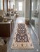 2' x 5' Runner Charcoal & Ivory Floral Traditional Washable Area Rug placed in a luxurious bathroom in front of a double vanity.