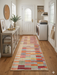 2' x 5' Runner Multi-Color Patchwork Striped Bohemian Area Rug styled in a laundry room.