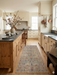 2' x 5' Runner Sage Green & Blush Floral Traditional Washable Area Rug styled in a kitchen with light wood cabinetry, brass fixtures, and soft natural lighting.