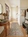 2' x 5' Runner Sage Green & Blush Floral Traditional Washable Area Rug styled in an entryway with a wooden console table, bench seating, and neutral decor.