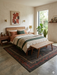 5' x 7' Rectangular Charcoal & Red Minimalist Tribal Border Modern Area Rug styled in a bedroom with a wooden bed frame and neutral decor.