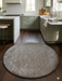 3' Round Taupe Gray Distressed Minimalist Modern Washable Area Rug placed in a kitchen with sage cabinetry, marble countertops, and warm wood flooring.