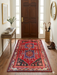 3' x 5' Rectangular Red & Blue Tribal Geometric Southwestern Washable Area Rug placed in a bright entryway with a wooden console table and round wall mirror.