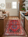 3' x 5' Rectangular Red & Blue Tribal Geometric Southwestern Washable Area Rug styled in a warm kitchen between natural wood cabinets and a large island.