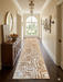 3' x 8' Runner Beige & Ivory Geometric Abstract Modern Washable Area Rug displayed in a bright hallway with classic architectural details, dark wood flooring, and sophisticated neutral furnishings.