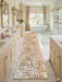 3' x 8' Runner Beige & Ivory Geometric Abstract Modern Washable Area Rug placed in a luxurious bathroom with marble flooring, a freestanding tub, and elegant transitional décor.