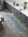 3' x 8' Runner Blue Gray Grid Modern Washable Area Rug styled in a contemporary kitchen with gray cabinetry, white countertops, and modern minimalist décor.