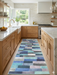 3' x 8' Runner Blue Mint Geometric Modern Washable Area Rug styled in a bright modern kitchen with natural wood cabinetry, white countertops, and gold-tone fixtures.