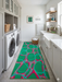 3' x 8' Runner Emerald Green & Pink Abstract Geometric Modern Washable Area Rug displayed in a clean laundry room with white cabinetry, farmhouse sink, and contemporary storage accents.