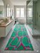 3' x 8' Runner Emerald Green & Pink Abstract Geometric Modern Washable Area Rug placed in a modern spa-inspired bathroom with marble floors, glass shower enclosure, and soft green décor.