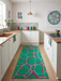 3' x 8' Runner Emerald Green & Pink Abstract Geometric Modern Washable Area Rug styled in a bright contemporary kitchen with white cabinetry, pastel accents, and natural wood flooring.