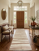 3' x 8' Runner Ivory & Blush Striped Modern Washable Area Rug displayed in an elegant entryway with wood flooring, classic furnishings, and soft neutral décor.