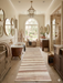 3' x 8' Runner Ivory & Blush Striped Modern Washable Area Rug placed in a luxurious bathroom with a freestanding tub, warm wood vanities, and spa-inspired transitional styling.