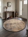 4' Round Beige & Brown Distressed Modern Abstract Area Rug styled in a welcoming entryway with wooden console table and décor accents.
