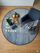 4' Round Blue & Ivory Geometric Minimalist Modern Area Rug styled in a living space with a modern chair, small side table, and minimal decor.