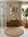 4 ft Round Natural Beige & Brown Woven Solid Modern Farmhouse Washable Area Rug styled in a modern bathroom.