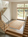 4' x 4' Square Ivory & Gold Floral Traditional Oriental Washable Area Rug styled in a modern entryway with staircase.
