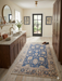 4' x 6' Rectangular Blue & Ivory Floral Traditional Area Rug styled in a spacious kitchen with traditional cabinetry.