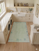 4' x 6' Rectangular Mint Green & Blue Gray Abstract Modern Area Rug placed in a clean laundry room with sink and cabinets.