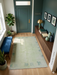 4' x 6' Rectangular Mint Green & Blue Gray Abstract Modern Area Rug styled in a modern entryway with console table and indoor plants.
