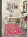 4' x 6' Rectangular Pink & Ivory Tribal Geometric Southwestern Area Rug showcased in an elegant bathroom with gold fixtures and blush accents.
