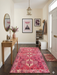 4' x 6' Rectangular Pink & Ivory Tribal Geometric Southwestern Area Rug styled in a bright entryway with a wooden console table and contemporary decor.
