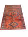 4' x 6' Rectangular Rust Red & Blue Tribal Geometric Medallion Traditional Area Rug isolated on a white background.