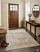 4' x 6' rectangular ivory multicolor distressed floral medallion traditional area rug placed in an entryway with a wooden door and console table.