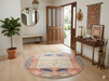 5' Round Peach & Blue Animal Motif Traditional Area Rug styled in an entryway with a console table and wall mirror.