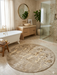 5' round beige & ivory marble abstract modern area rug placed in a luxurious bathroom with a freestanding tub and warm natural finishes.