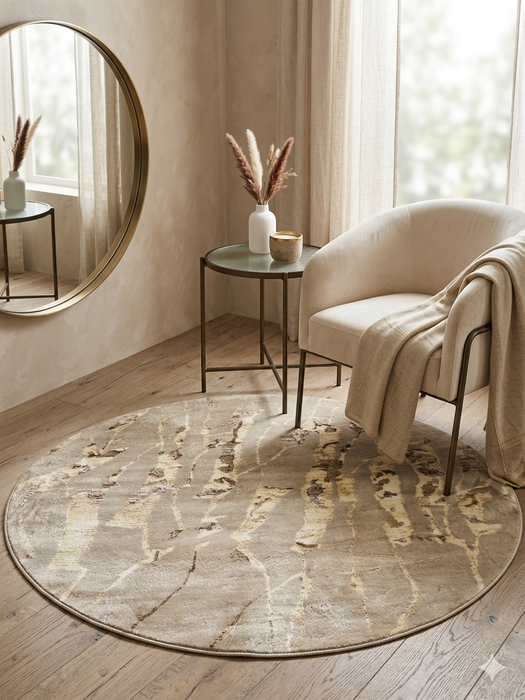 5' round beige & ivory marble abstract modern area rug styled in a cozy reading nook with a curved accent chair and soft neutral décor.